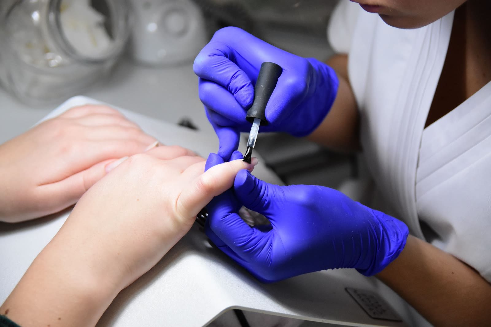 Nail polish being applied during a manicure at Lavish Looks